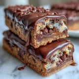 Vibrant graduation cookie bars topped with colorful candy-coated chocolates and a smooth white chocolate drizzle, perfect for celebrating academic success.