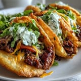 Fluffy cloud bread taco shells filled with vibrant seasoned beef and garnishes.