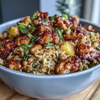 Vibrant sweet chili chicken pineapple fried rice with tender chicken, colorful vegetables, and juicy pineapple in a zesty sauce.